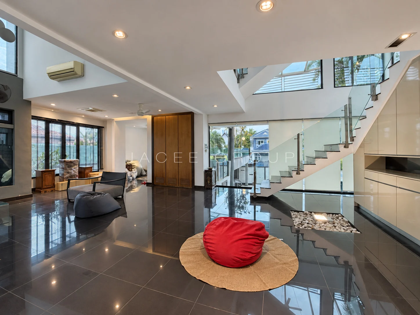Living Hall and Glass Staircase at the Damansara Heights modern bungalow