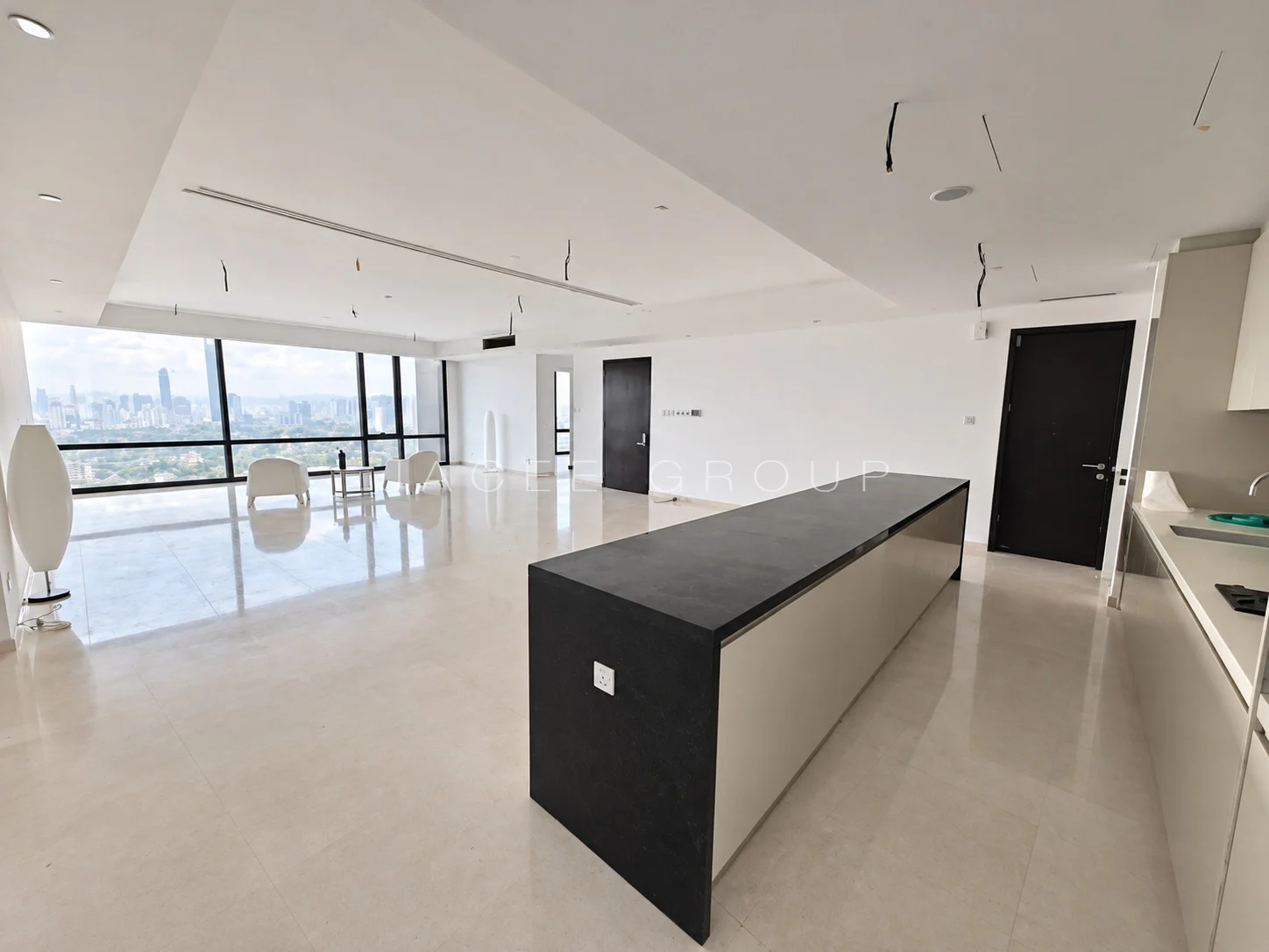 Living area and kitchen island at Crown Residences Pavilion Damansara Heights, 2803 sq ft home for sale